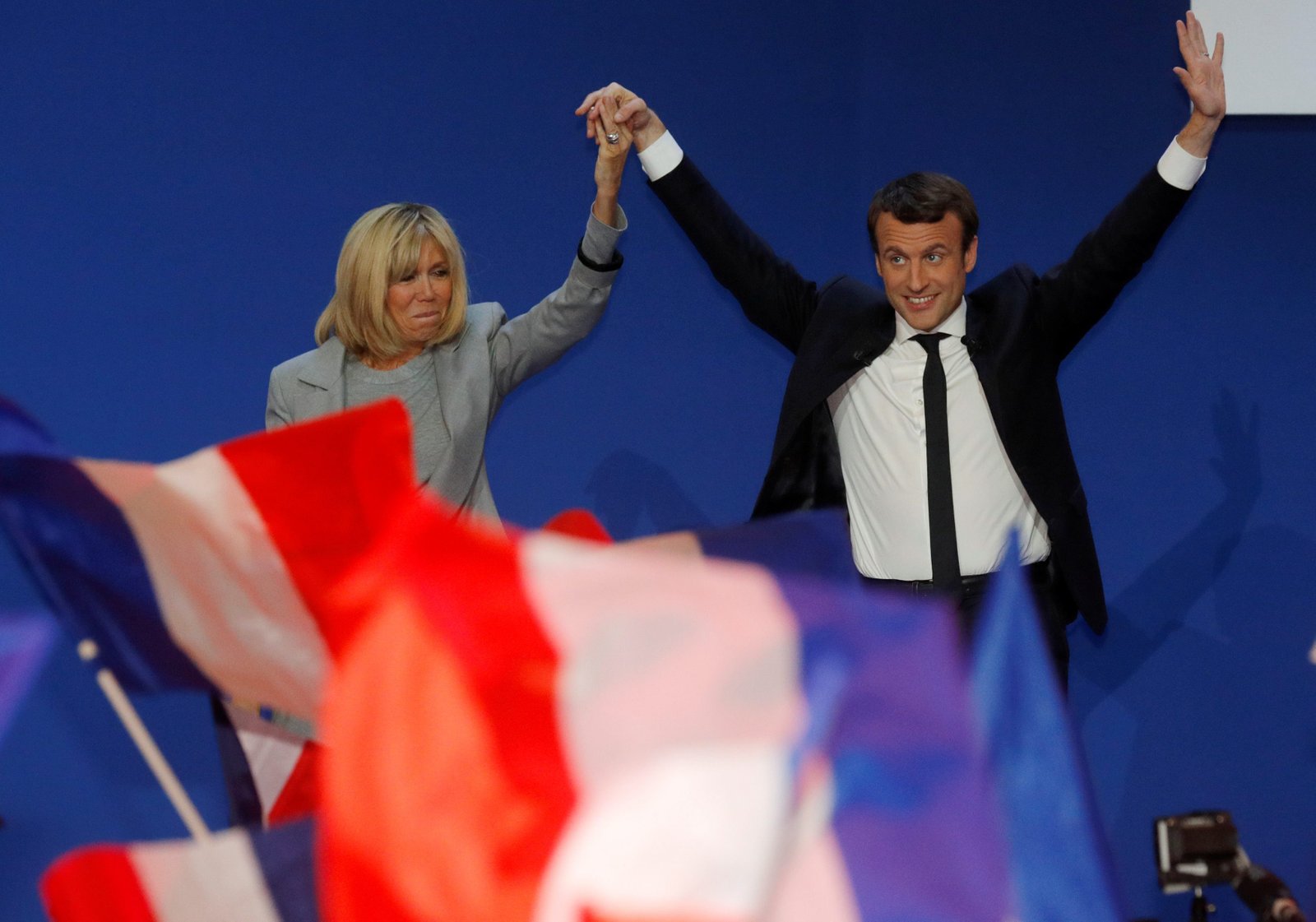 Emmanuel Macron, head of the political movement En Marche !, or Onwards !, and candidate for the 2017 French presidential election, arrives on stage with his wife Brigitte Trogneux to deliver a speech at the Parc des Expositions hall in Paris after early results in the first round of 2017 French presidential election, France, April 23, 2017. REUTERS/Philippe Wojazer