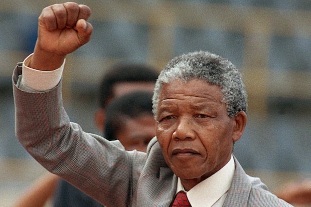 Anti-apartheid leader and African National Congress (ANC) member Nelson Mandela raises clenched fist, arriving to address mass rally, a few days after his release from jail, 25 February 1990, in the conservative Afrikaaner town of Bloemfontein, where ANC was formed 75 years ago.        (Photo credit should read TREVOR SAMSON/AFP/Getty Images)